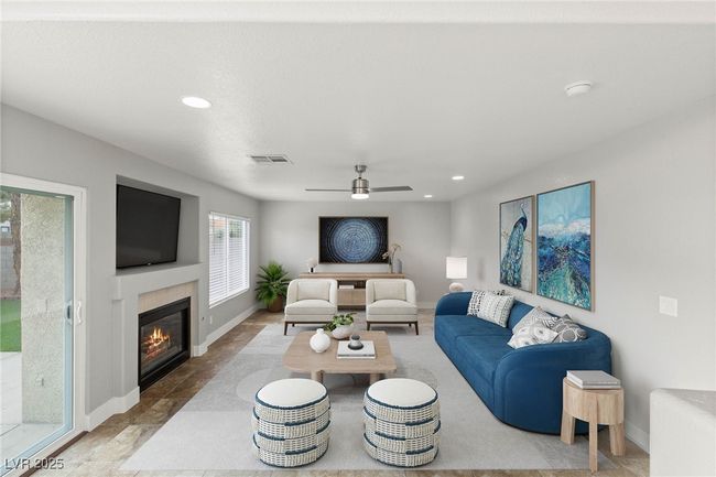 Living room with recessed lighting, a glass covered fireplace, visible vents, and baseboards | Image 14