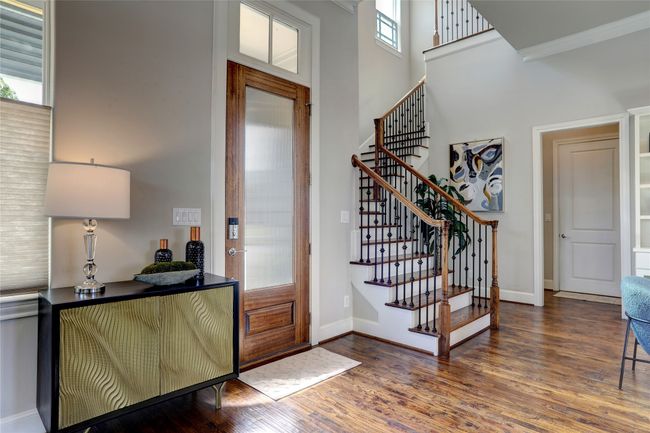 Foyer entrance connecting to the stairway, the utility room and garage. Look at the soaring ceilings! | Image 18