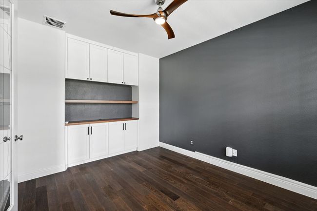 Spare room featuring a ceiling fan and dark wood finished floors | Image 4