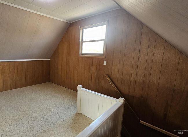 Bonus room featuring vaulted ceiling and wooden walls | Image 18