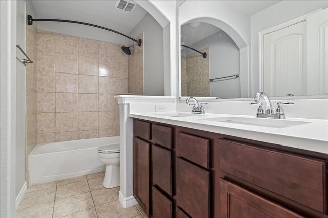Full bath with tile patterned flooring, toilet, and a sink | Image 28