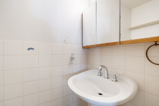 Bathroom featuring tile walls and a sink | Image 28