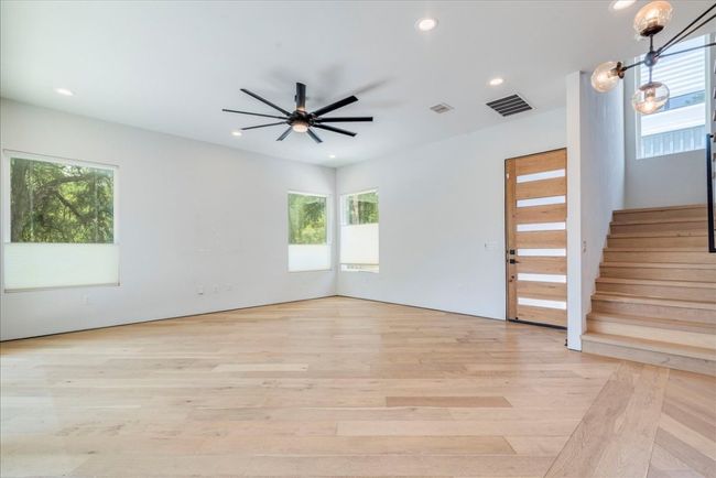 Spare room with plenty of natural light, light wood-type flooring, recessed lighting, and ceiling fan | Image 5