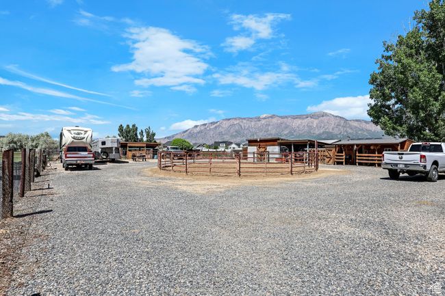 View of dirt / gravel road with a mountain view and an exterior structure | Image 38