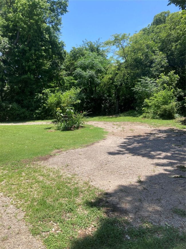 View of driveway at back of house featuring a forest view | Image 6