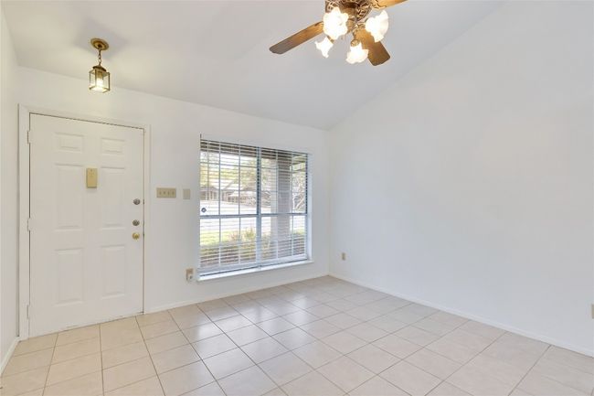 Foyer featuring a ceiling fan, vaulted ceiling, and light tile patterned floors | Image 8