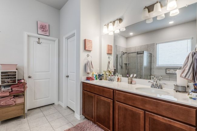 Full bath with a stall shower, tile patterned flooring, and double vanity | Image 13