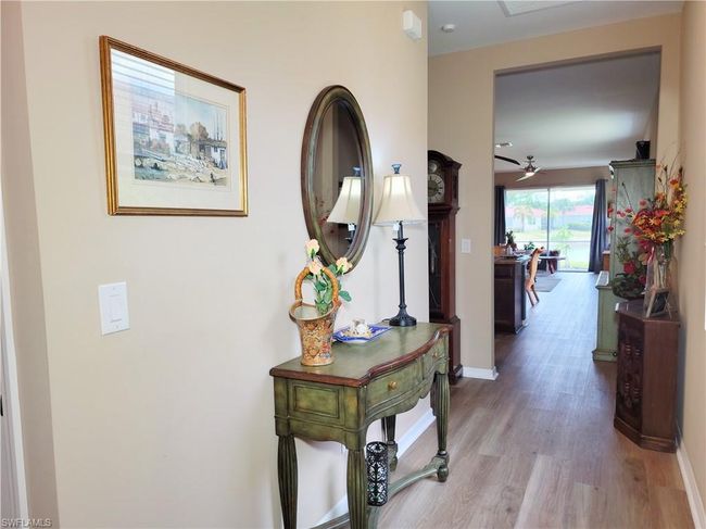 Hall with baseboards and wood finished floors | Image 8