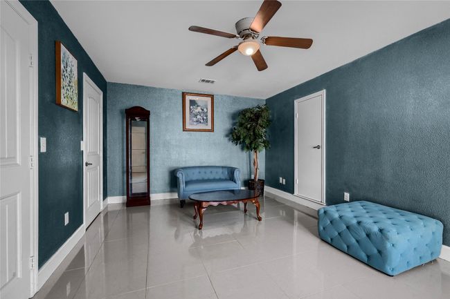 Living area featuring ceiling fan and light tile patterned flooring | Image 23