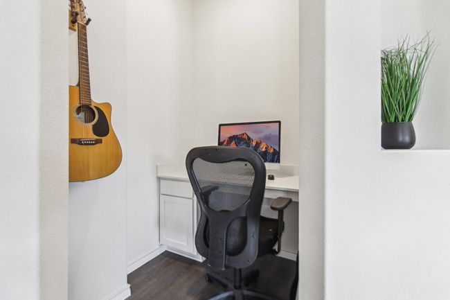 Office area with dark wood-type flooring and baseboards | Image 21