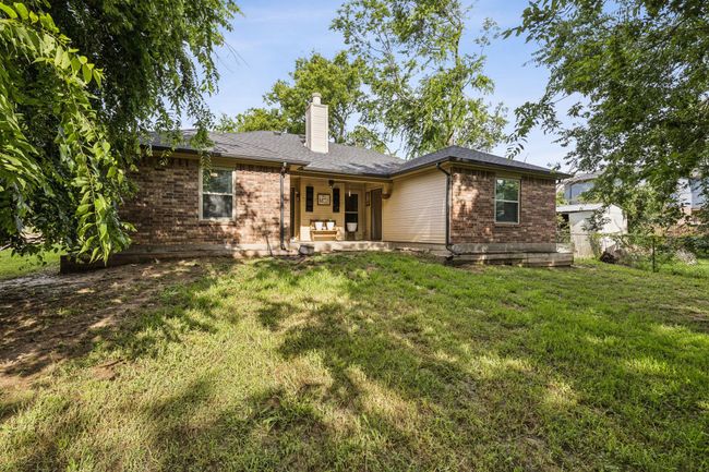 Back of property featuring brick siding and a chimney | Image 25