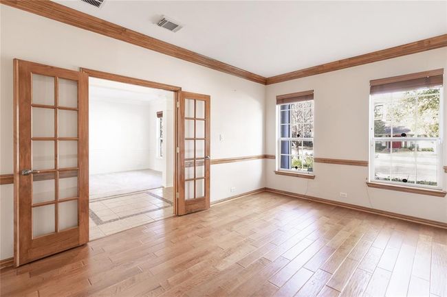 Office space/study features double doors, wood flooring, and a charming front-facing view, this study offers a quiet and stylish space to work. | Image 19
