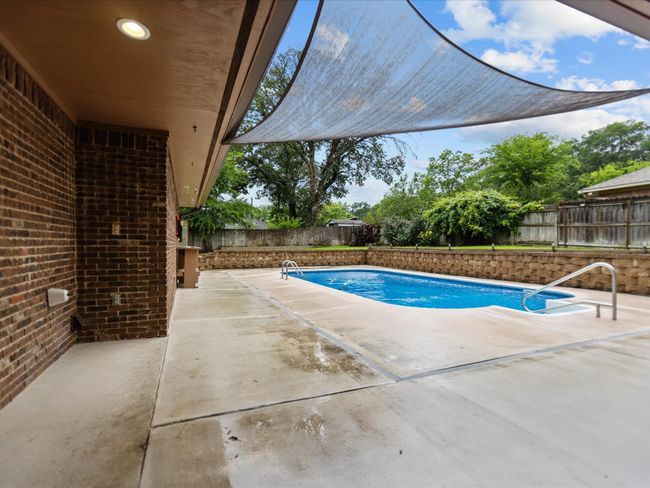 View of pool featuring a fenced backyard and a patio | Image 9
