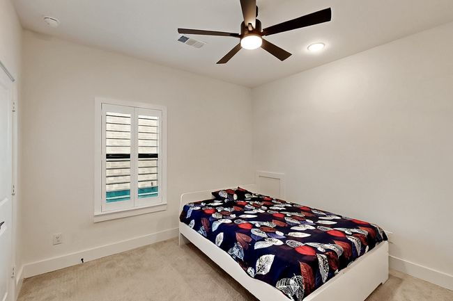 Carpeted bedroom featuring baseboards and a ceiling fan | Image 24