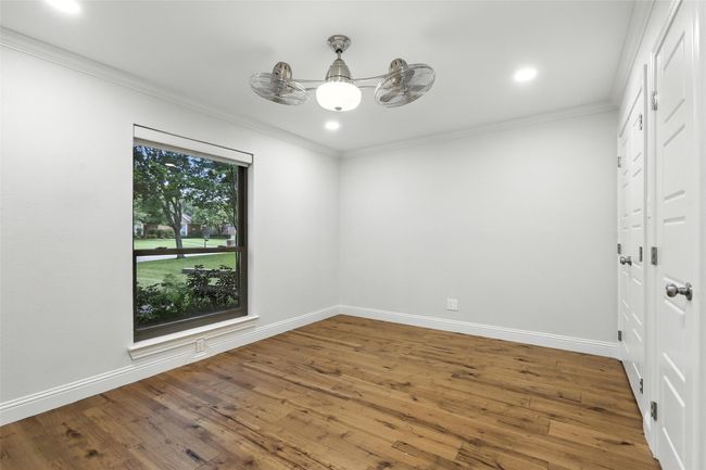 Spare room featuring wood finished floors, crown molding, recessed lighting, and a chandelier | Image 28