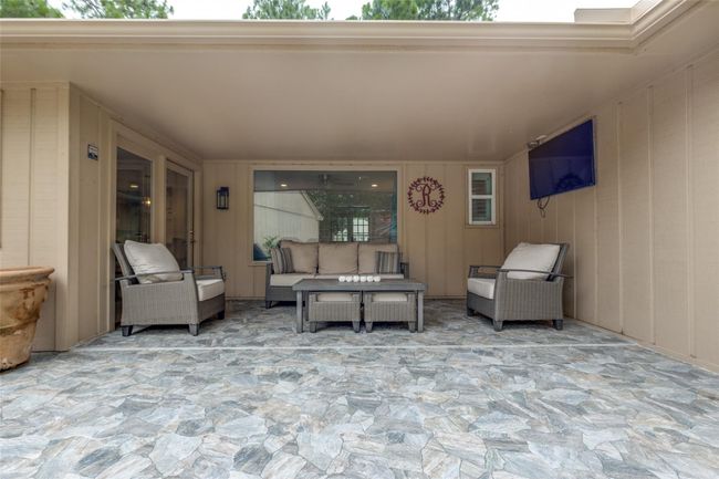 Outdoor covered patio, which is great for entertaining and for the kids to play in the backyard. The mounted TV will stay with the sale. | Image 22