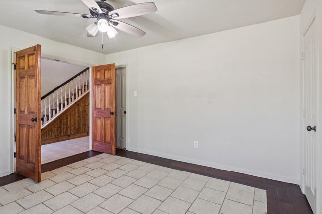 Opposite the study is a first floor bedroom. This room offers double doors, a closet and an adjacent full bathroom. | Image 8