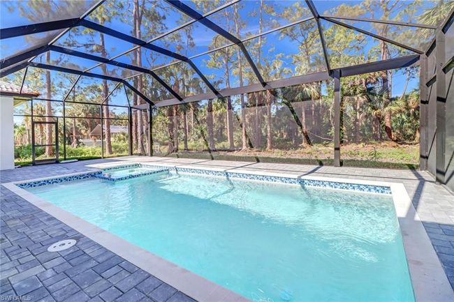 View of pool with a patio area and glass enclosure | Image 45
