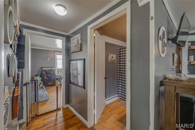 Foyer featuring ornamental molding, wood finished floors, and baseboards | Image 15
