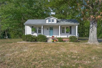 View of front of home featuring a front yard and a porch | Image 1