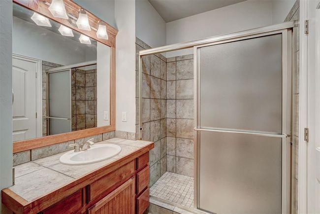 Bathroom with vanity and a shower stall | Image 32