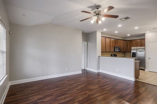 Open floor plan showing view from family room into the kitchen. | Image 6