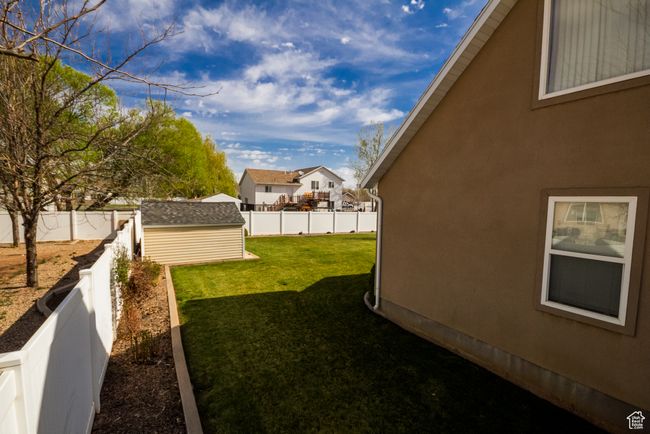 View of yard featuring an outbuilding, a shed, a residential view, and a fenced backyard | Image 30
