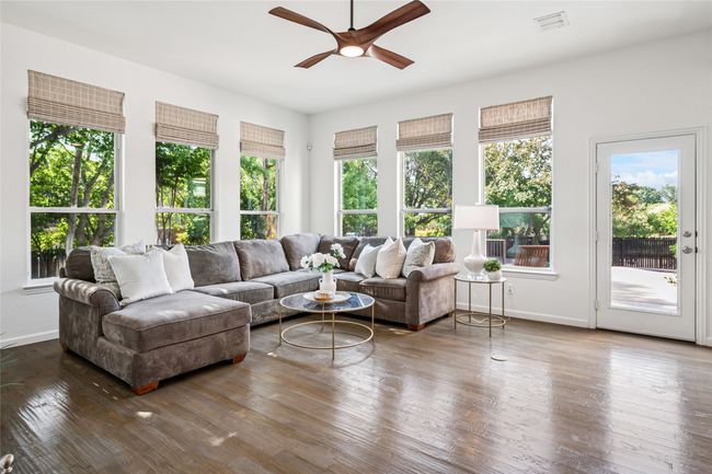 Living area with tons of natural light. Windows overlook the yard. | Image 7