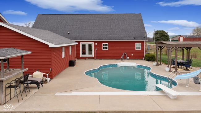 outdoor pool with a patio, outdoor dry bar, and a water slide | Image 47