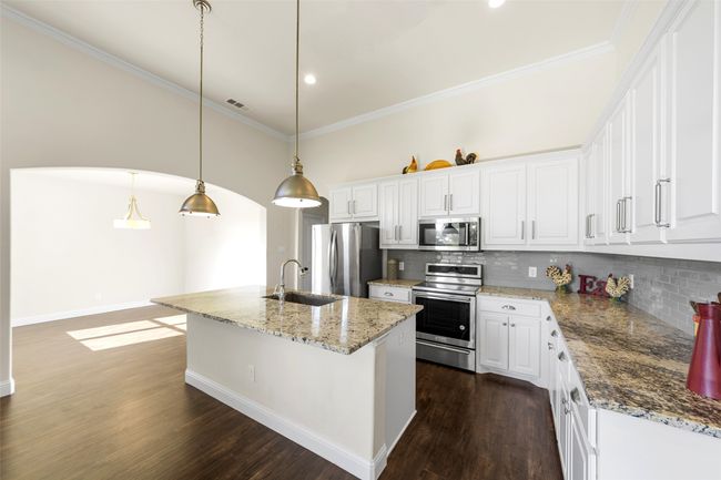 Check out the many cabinets and counter space this modern kitchen contains! | Image 12
