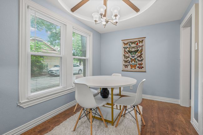 Dining room with a chandelier and wood finished floors | Image 10