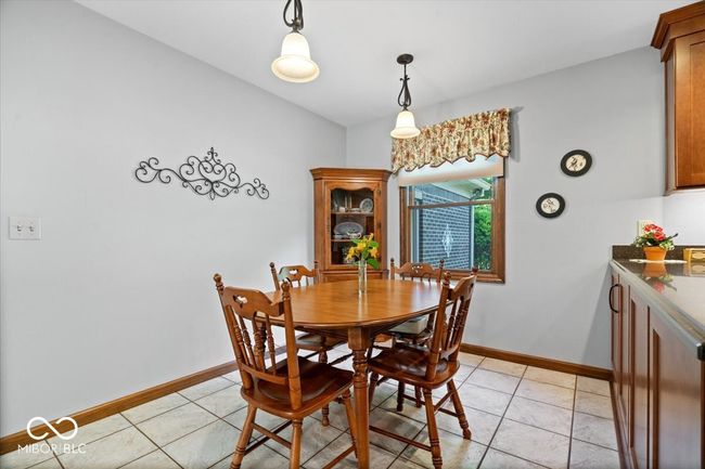 dining space with baseboards and light tile patterned floors | Image 15