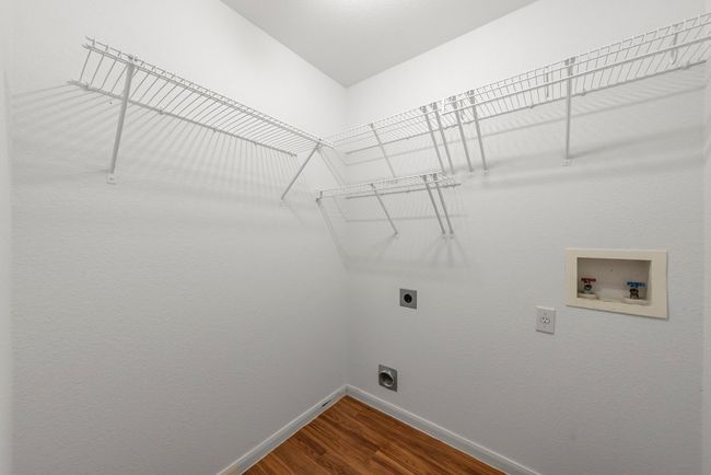 Laundry area with baseboards, washer hookup, laundry area, dark wood-style floors, and electric dryer hookup | Image 10