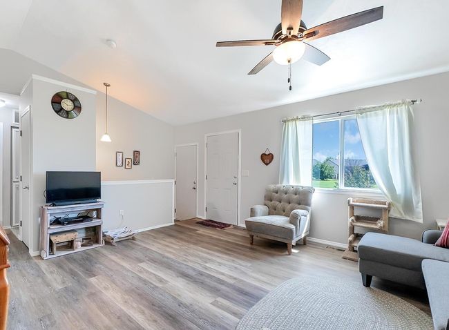 Living room featuring lofted ceiling, ceiling fan, and wood finished floors | Image 9