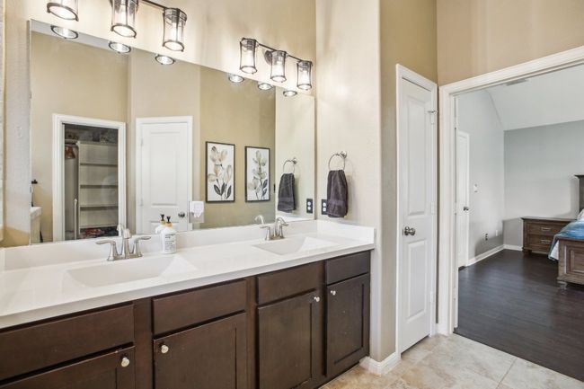 Bathroom featuring tile patterned floors, a sink, and double vanity | Image 18