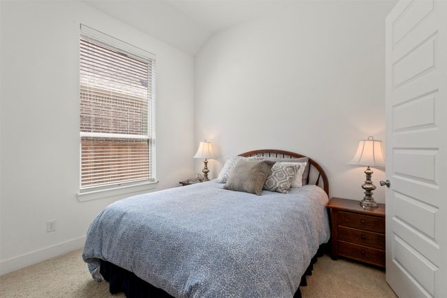 Bedroom featuring carpet and vaulted ceiling | Image 13