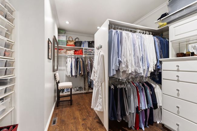 Walk In closet with hardwood floors and dual built-in dressers | Image 21