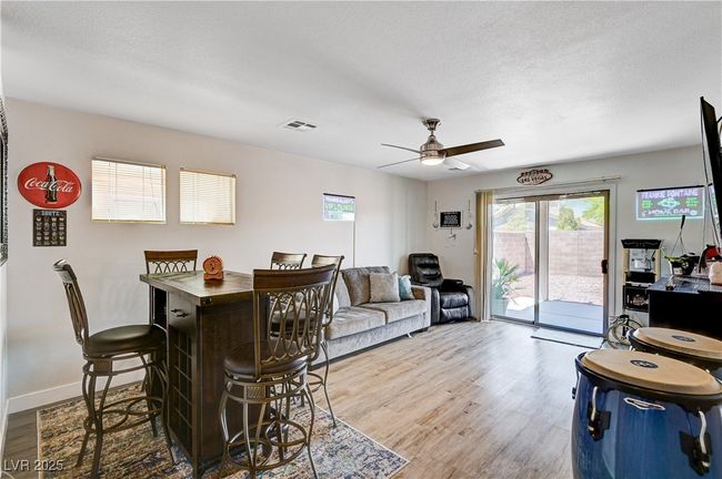 Dining area featuring wood finished floors, ceiling fan, and a textured ceiling | Image 22