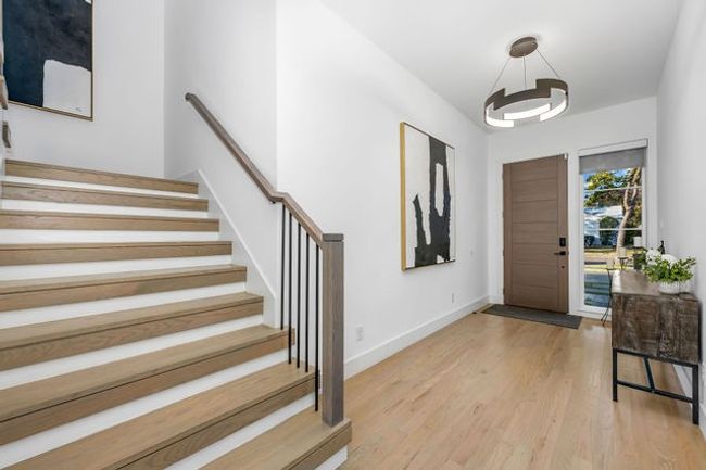 Entryway with a chandelier and light hardwood / wood-style flooring | Image 26