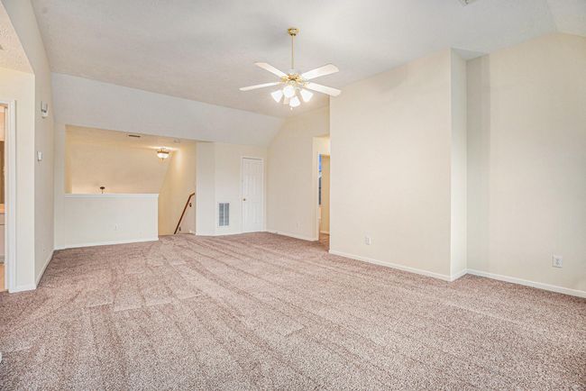 Additional view of game room looking toward staircase with large walk-in decked attic. | Image 30