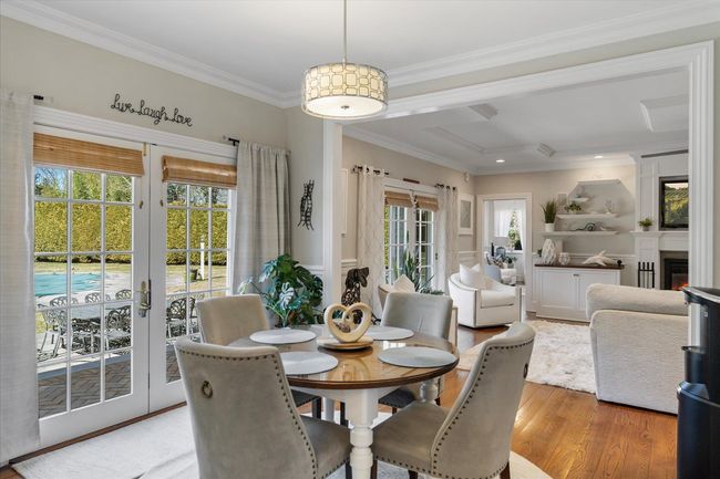 Dining space with plenty of natural light, light wood-type flooring, ornamental molding, and french doors | Image 13