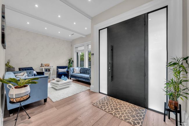 Entrance foyer featuring vaulted ceiling with beams, light wood-style flooring, and recessed lighting | Image 14