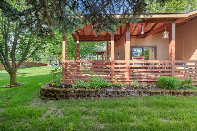 View of green lawn featuring a wooden deck | Image 36