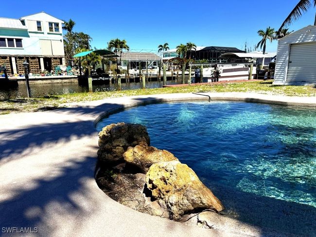 Outdoor pool featuring a water view and a dock | Image 20
