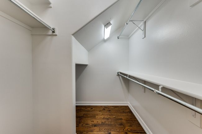 Spacious closet with wood finished floors | Image 15