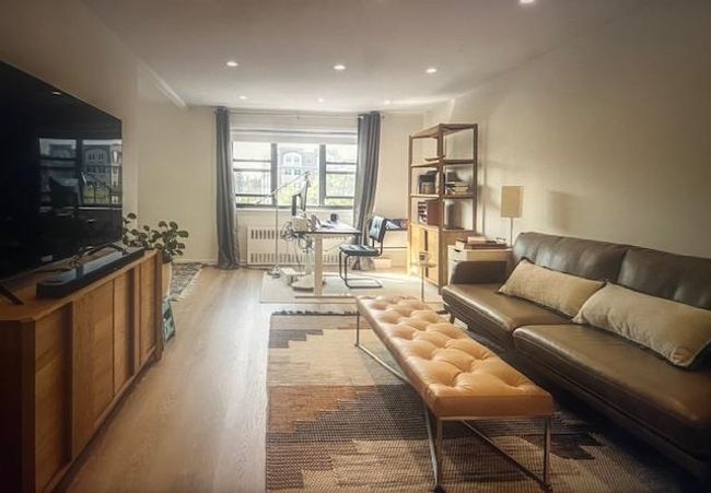 Living room with light wood-style floors, recessed lighting, and radiator heating unit | Image 13