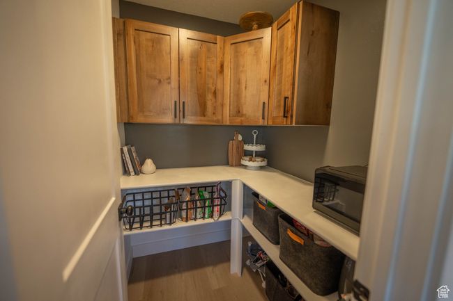 Spacious walk-in butler’s pantry, complete with custom cabinetry, functional countertops, and built-in shelving—perfect for keeping your kitchen organized and clutter-free while offering additional prep and storage space. | Image 11