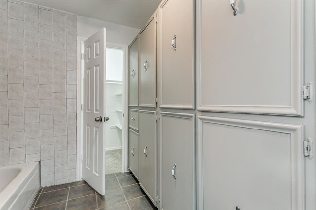 Full bath featuring tile patterned floors and a bathing tub | Image 23