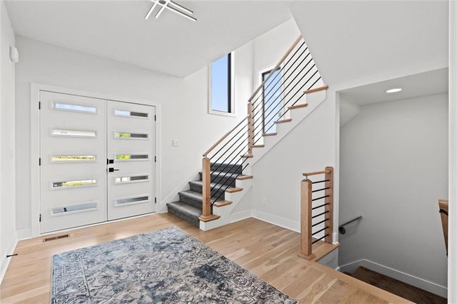 Foyer with light wood-type flooring and stairs | Image 24