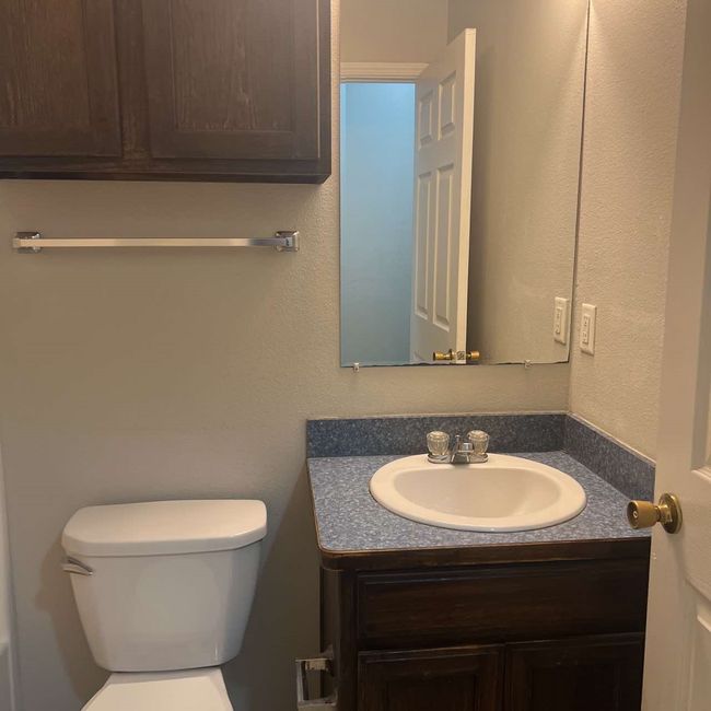 Bathroom featuring vanity and a textured wall | Image 14